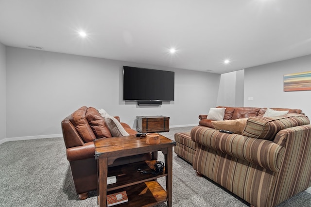 living area featuring baseboards, visible vents, and light colored carpet