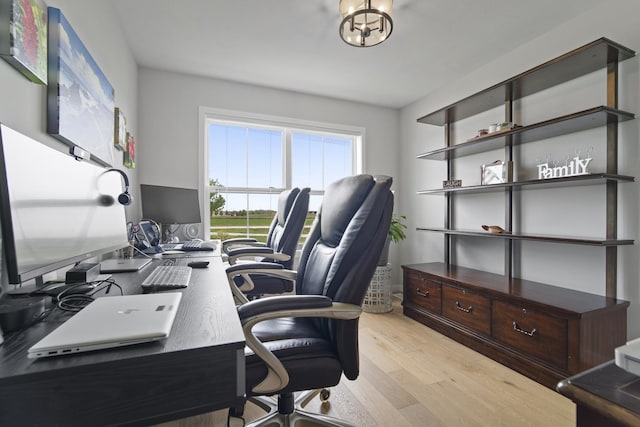 office featuring an inviting chandelier and light wood-style flooring