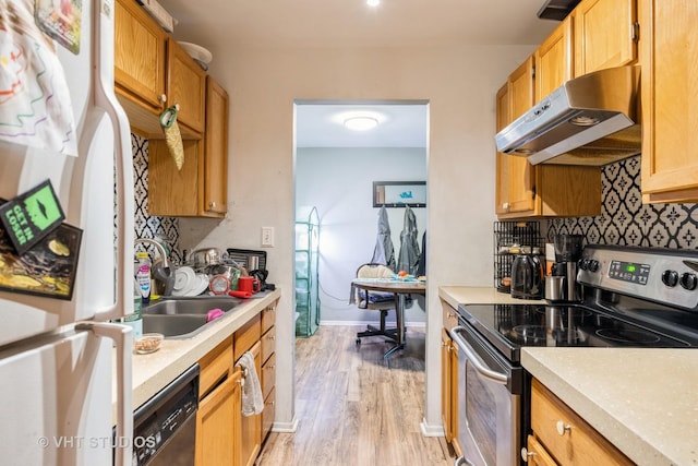 kitchen featuring freestanding refrigerator, stainless steel electric range, dishwashing machine, under cabinet range hood, and light countertops