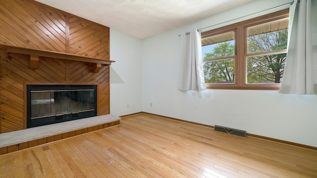 4401 Windsor Ct, Loves Park, IL 61111 - unfurnished living room with baseboards, a large fireplace, hardwood / wood-style floors, and visible vents