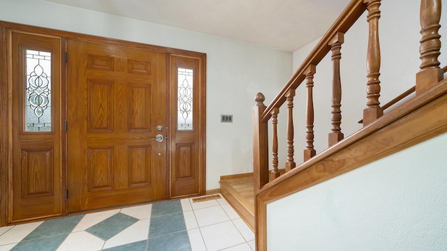 4401 Windsor Ct, Loves Park, IL 61111 - foyer entrance featuring light tile patterned floors, stairs, and visible vents