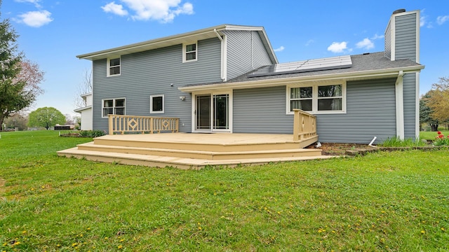 4401 Windsor Ct, Loves Park, IL 61111 - rear view of house with a lawn, a chimney, solar panels, and a wooden deck