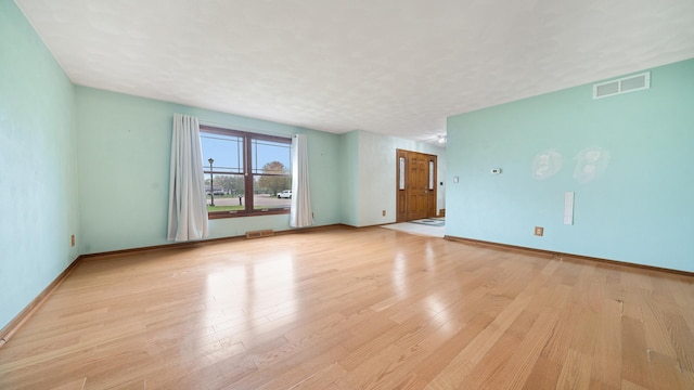 4401 Windsor Ct, Loves Park, IL 61111 - unfurnished living room featuring baseboards, light wood finished floors, and visible vents