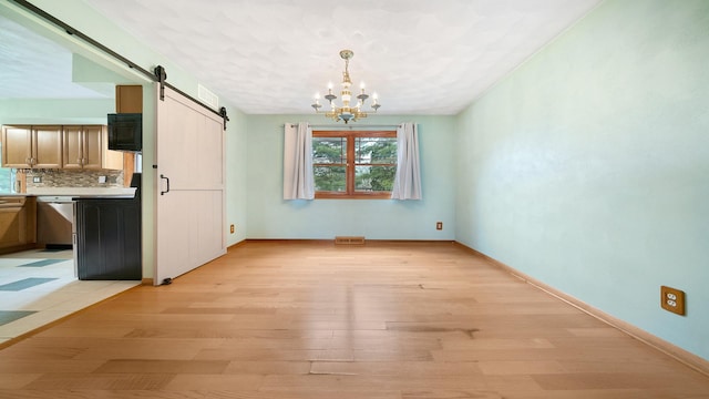 4401 Windsor Ct, Loves Park, IL 61111 - unfurnished dining area with visible vents, a barn door, baseboards, light wood finished floors, and an inviting chandelier