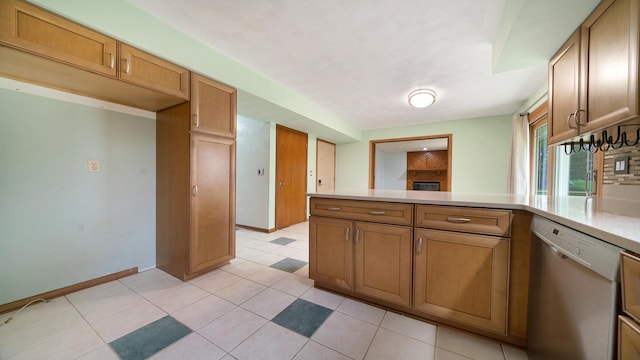 4401 Windsor Ct, Loves Park, IL 61111 - kitchen featuring light countertops, a peninsula, baseboards, light tile patterned floors, and dishwashing machine