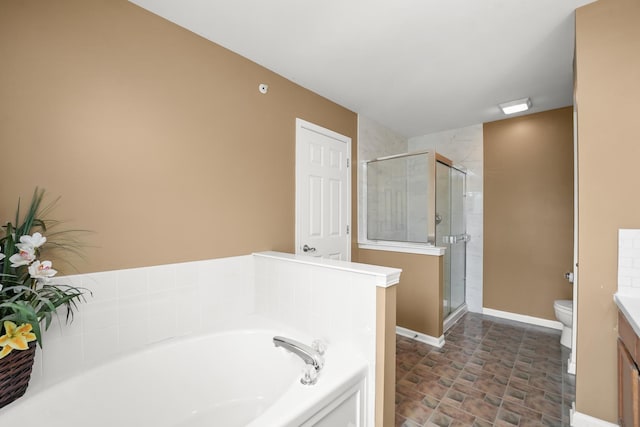 full bathroom featuring a garden tub, toilet, a shower stall, and vanity
