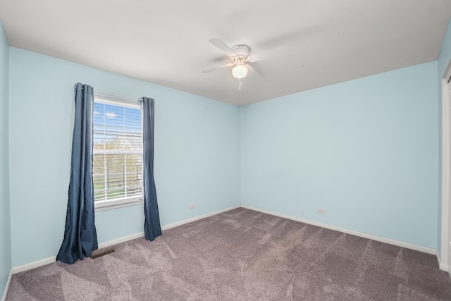unfurnished room with ceiling fan, carpet, baseboards, and visible vents