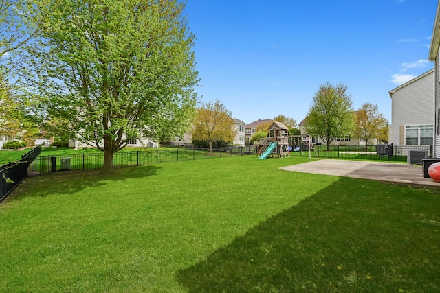 view of yard with a playground, a patio, and a fenced backyard