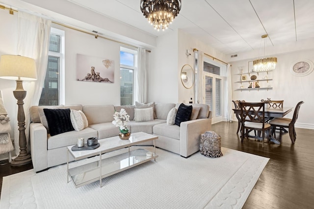 1111 W Madison St Unit 5B, Chicago, IL 60607 - living room featuring visible vents, a chandelier, and dark wood-style floors