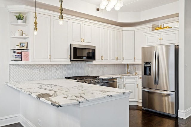 1111 W Madison St Unit 5B, Chicago, IL 60607 - kitchen with stainless steel appliances, open shelves, white cabinetry, and a peninsula