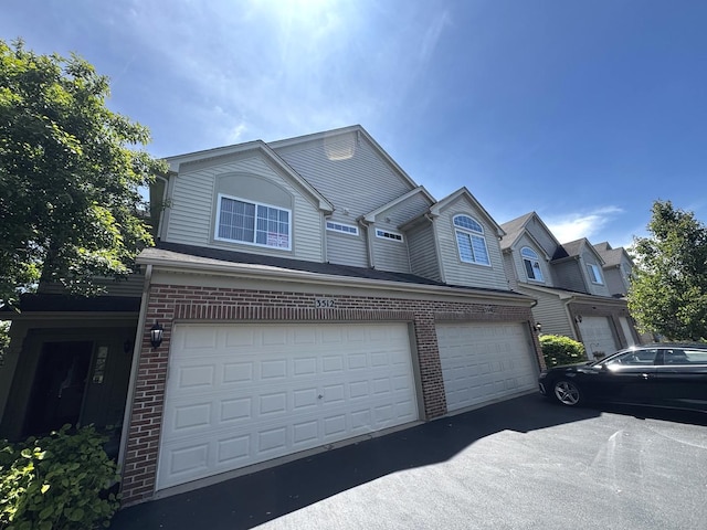 3512 Blue Ridge Ct, Carpentersville, IL 60110 - view of front of home featuring an attached garage, brick siding, and driveway