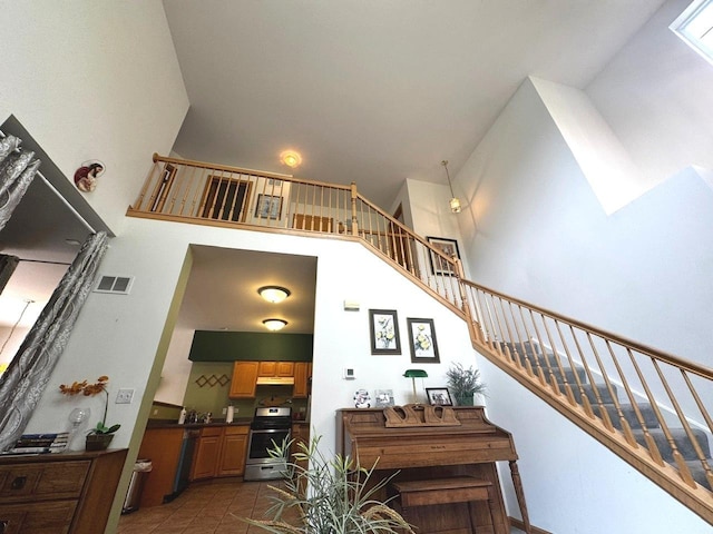 3512 Blue Ridge Ct, Carpentersville, IL 60110 - stairs with a high ceiling and tile patterned floors