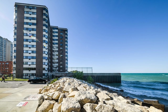 exterior space featuring a water view and uncovered parking