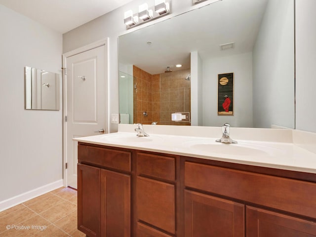 100 E 14th St Unit 1502, Chicago, IL 60605 - bathroom with double vanity, tiled shower, a sink, and visible vents