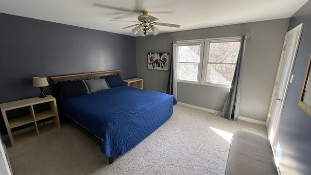bedroom featuring ceiling fan, light colored carpet, and baseboards