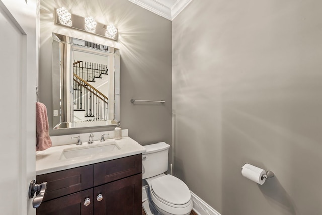 half bath with crown molding, toilet, and vanity