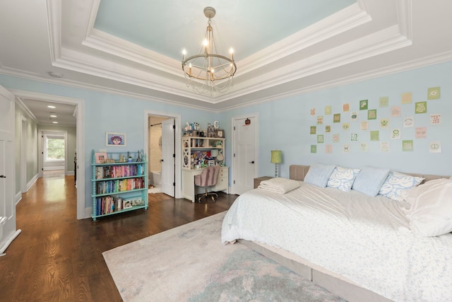 bedroom featuring crown molding, dark wood finished floors, a tray ceiling, and a notable chandelier