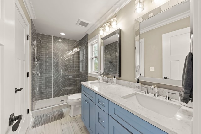 bathroom with toilet, visible vents, a shower stall, and a sink