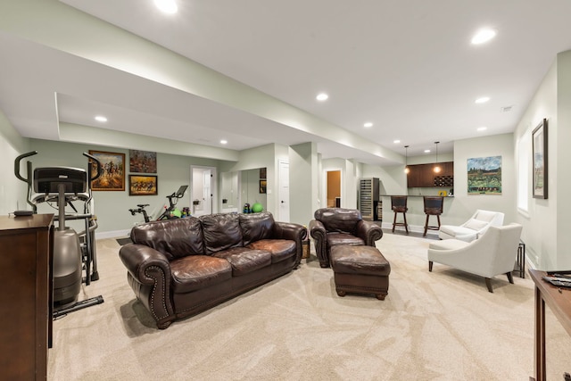carpeted living room with indoor bar, recessed lighting, and baseboards