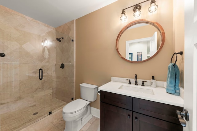 bathroom with tile patterned flooring, vanity, toilet, baseboards, and a shower stall