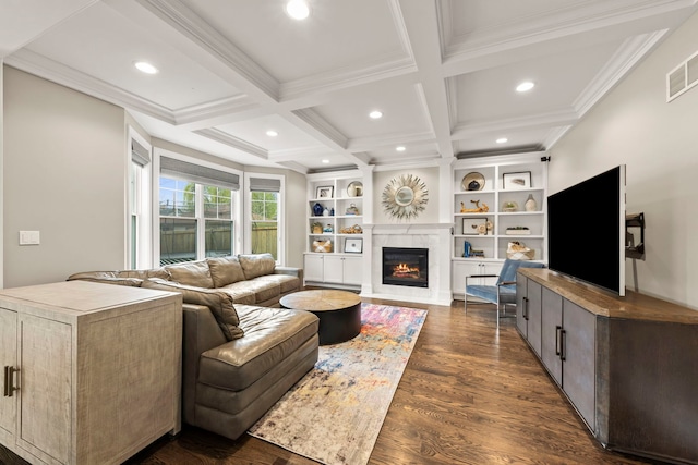 living room featuring crown molding, a glass covered fireplace, beam ceiling, and dark wood-type flooring