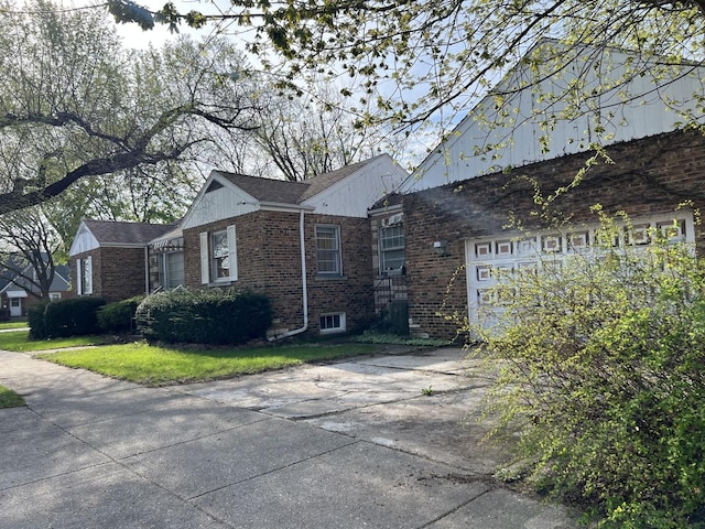 view of side of home with brick siding and driveway