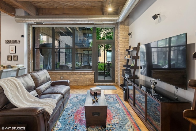 1040 W Adams St Unit 203, Chicago, IL 60607 - living area featuring healthy amount of natural light, wood finished floors, brick wall, and wooden ceiling