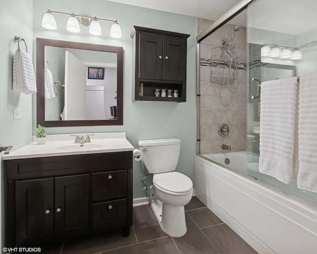 1040 W Adams St Unit 203, Chicago, IL 60607 - bathroom featuring toilet, vanity, combined bath / shower with glass door, and baseboards