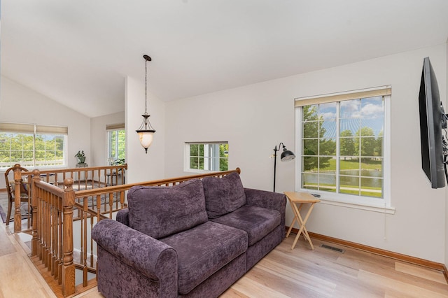 2270 Twilight Dr Unit 2270, Aurora, IL 60503 - living room with light wood-style floors, lofted ceiling, and baseboards