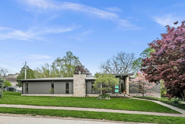 221 Parkview Dr, Bloomington, IL 61701 - view of front of house with a standing seam roof, a front lawn, stone siding, and metal roof