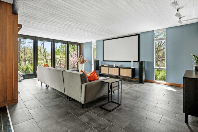 221 Parkview Dr, Bloomington, IL 61701 - home theater with rail lighting, wooden ceiling, and dark tile patterned floors