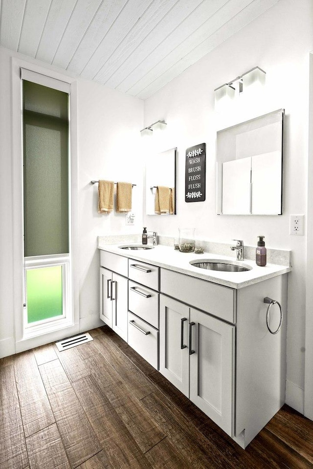 221 Parkview Dr, Bloomington, IL 61701 - bathroom with double vanity, wood finished floors, and wooden ceiling