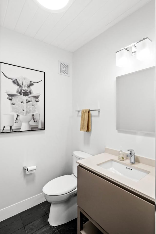221 Parkview Dr, Bloomington, IL 61701 - half bathroom featuring toilet, vanity, baseboards, and tile patterned floors