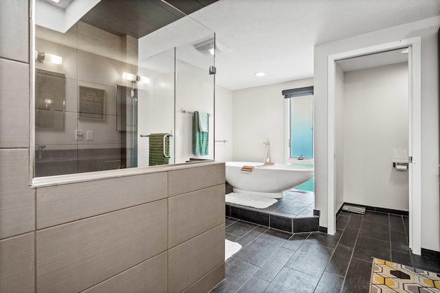 221 Parkview Dr, Bloomington, IL 61701 - full bathroom with a shower stall, a freestanding bath, recessed lighting, and baseboards