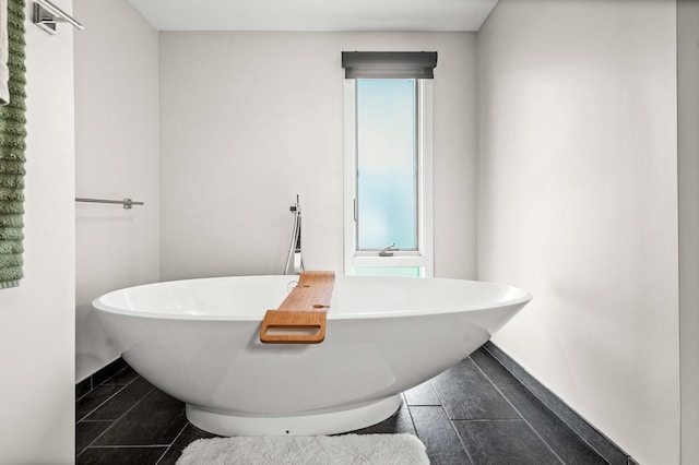 221 Parkview Dr, Bloomington, IL 61701 - full bathroom featuring a freestanding bath and baseboards
