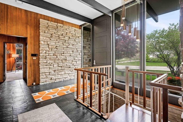 221 Parkview Dr, Bloomington, IL 61701 - hallway with wooden walls and an upstairs landing