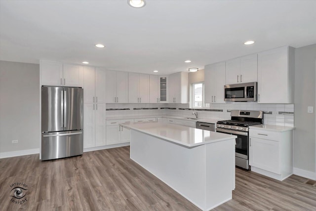 26165 County Fair Dr, Monee, IL 60449 - kitchen with light countertops, appliances with stainless steel finishes, backsplash, and white cabinetry