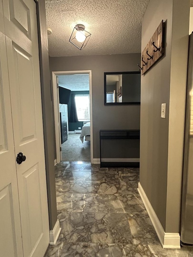 1216 S New Wilke Rd Unit 106, Arlington Heights, IL 60005 - hall featuring baseboards and a textured ceiling