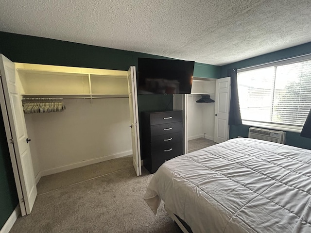 1216 S New Wilke Rd Unit 106, Arlington Heights, IL 60005 - bedroom featuring multiple closets, baseboards, a textured ceiling, a wall unit AC, and carpet flooring