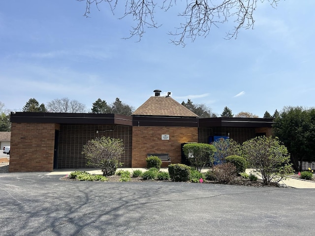 1216 S New Wilke Rd Unit 106, Arlington Heights, IL 60005 - view of side of property featuring brick siding