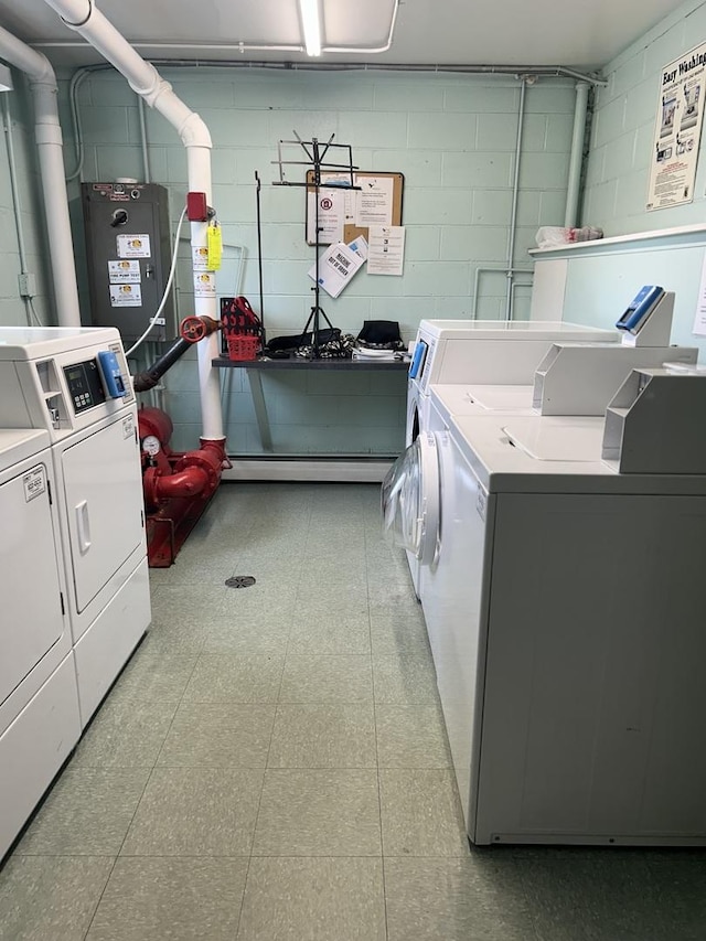 1216 S New Wilke Rd Unit 106, Arlington Heights, IL 60005 - community laundry room with separate washer and dryer, light floors, and concrete block wall