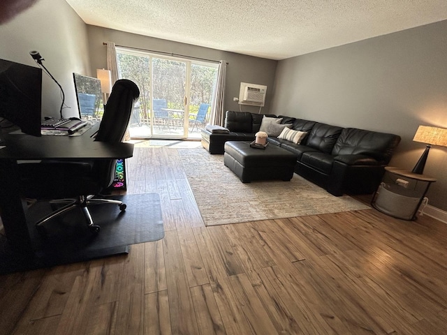 1216 S New Wilke Rd Unit 106, Arlington Heights, IL 60005 - home office with a textured ceiling, a wall unit AC, and wood finished floors