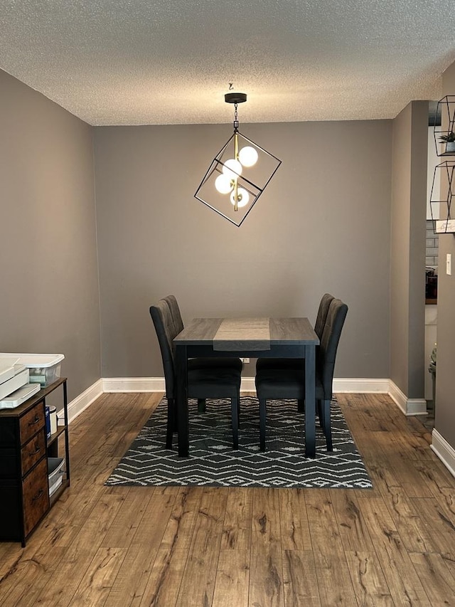 1216 S New Wilke Rd Unit 106, Arlington Heights, IL 60005 - dining space with baseboards, a textured ceiling, and hardwood / wood-style flooring