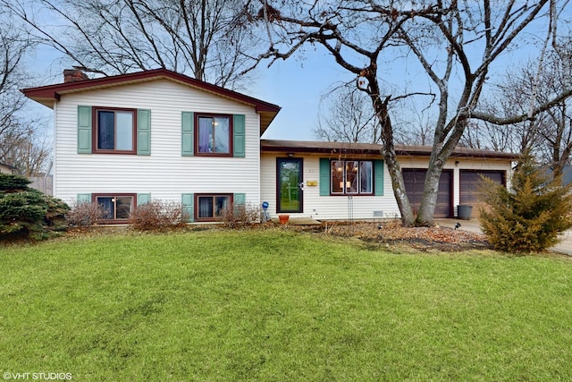 tri-level home featuring an attached garage, a front lawn, a chimney, and concrete driveway