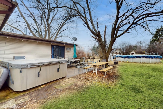 view of yard with a hot tub, a covered pool, and a patio area