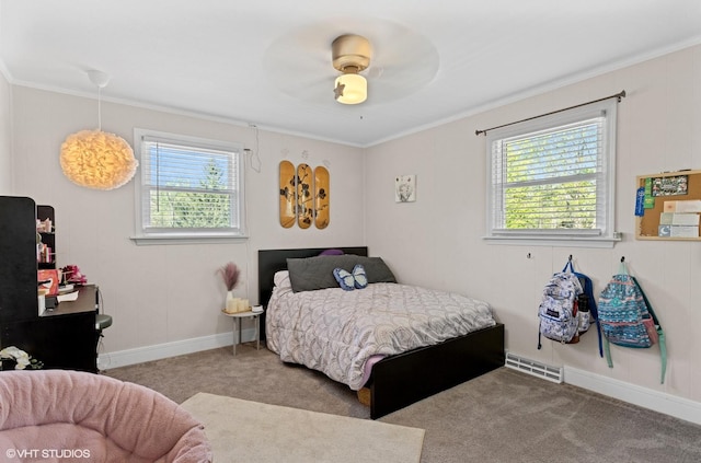 bedroom with multiple windows, carpet, ornamental molding, ceiling fan, and baseboards