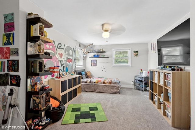 carpeted bedroom featuring a ceiling fan and baseboards