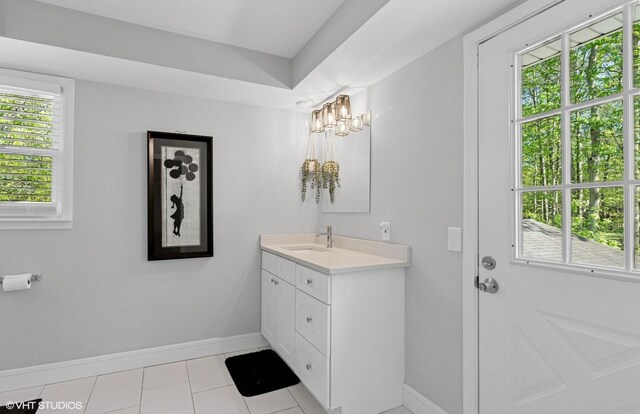 bathroom featuring baseboards, vanity, and tile patterned flooring