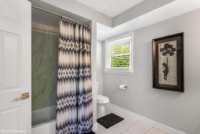 bathroom featuring baseboards, toilet, shower / bath combination with curtain, and tile patterned flooring