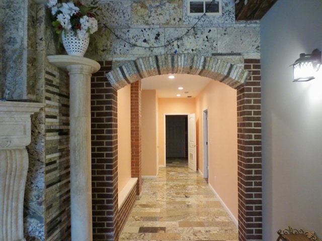 hall with visible vents, arched walkways, baseboards, and recessed lighting